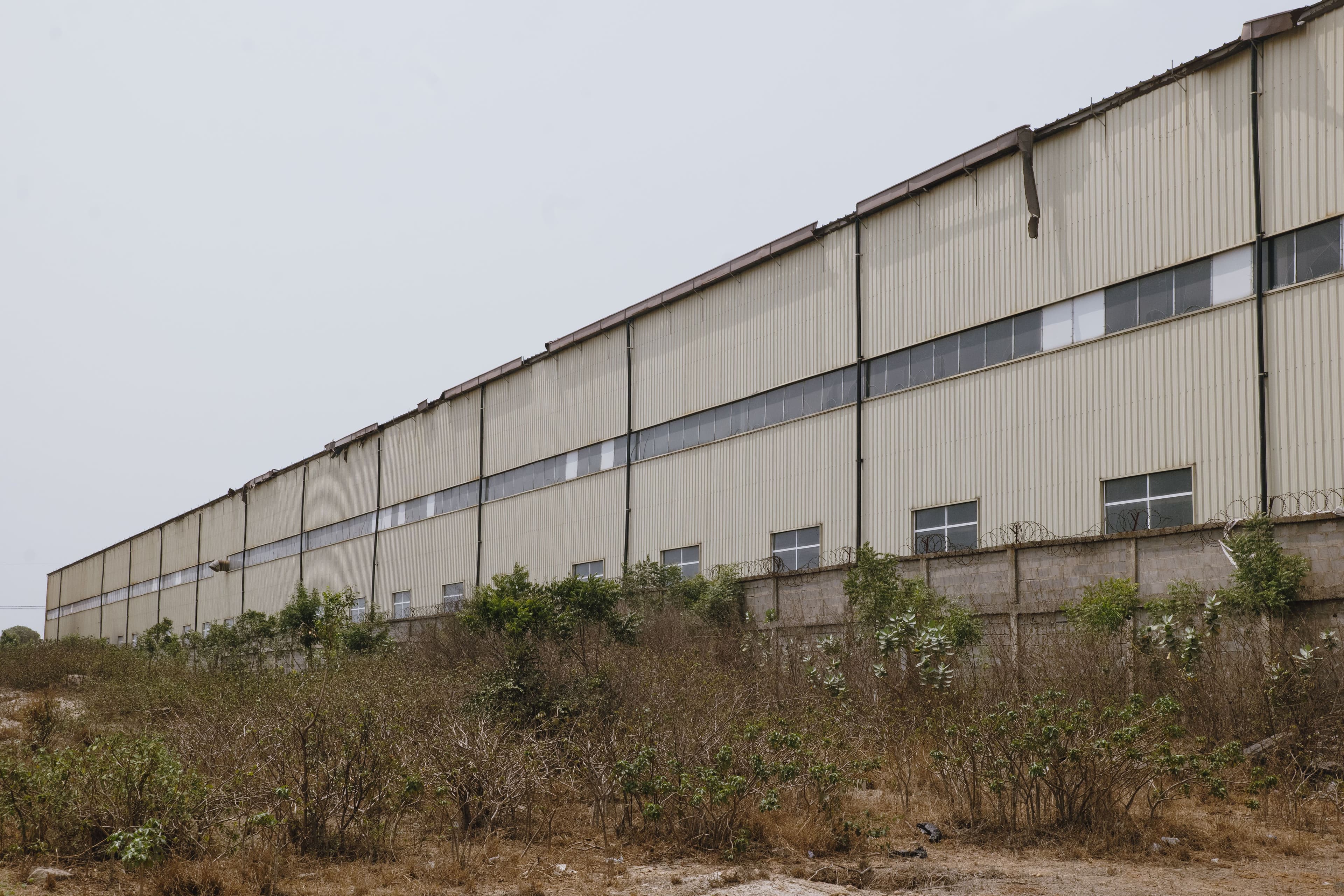 Large commercial warehouse exterior viewed during a property visit.